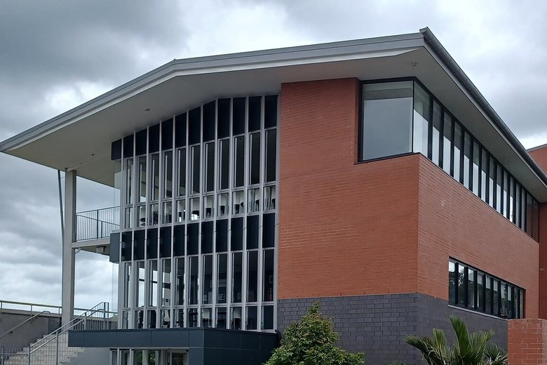 A modern brick and glass teaching block at a secondary school in Auckland